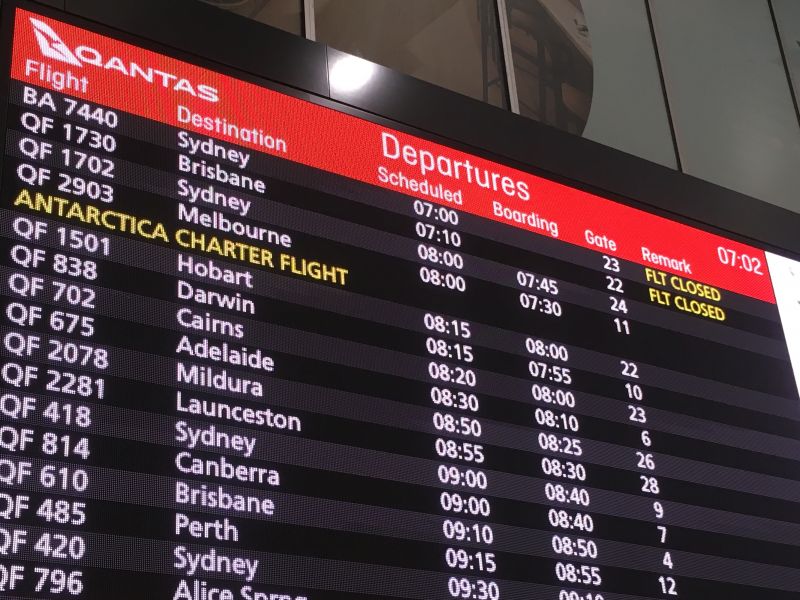 Airport departure board showing Antarctica charter flight
