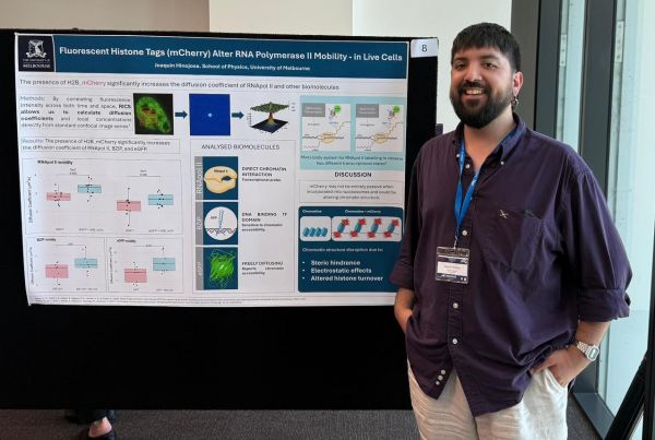 Student standing in front of a poster presentation.