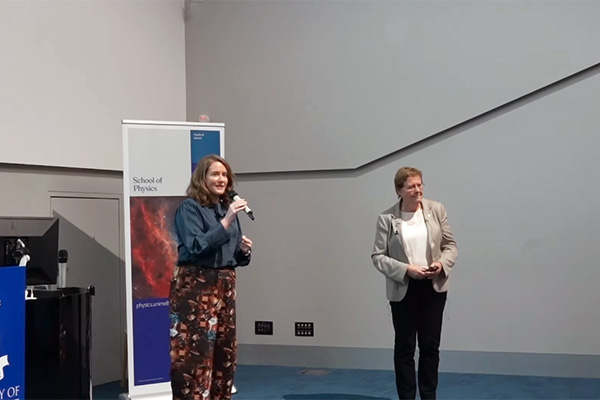 Suzie Sheehy and Rachel Webster standing at the front of a lecture theatre presenting